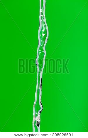 a jet of water on a green background