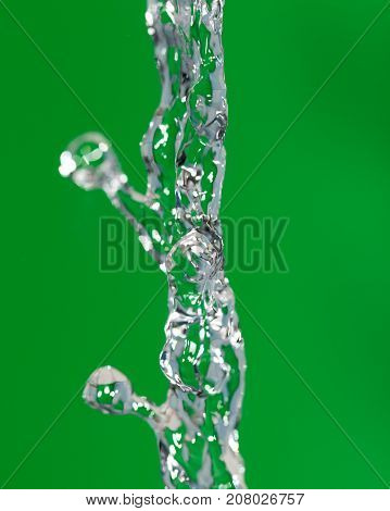 a jet of water on a green background