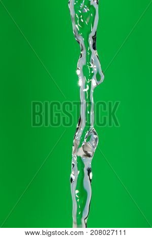 a jet of water on a green background
