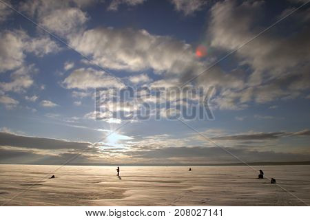 Fisherman On The River Covered With Ice