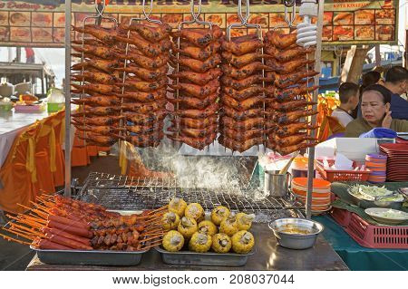 KOTA KNABALU MALAYSIA - AUGUST 1 2017: Grilled chicken wings chicken tails and corn at street market Kota kinabalu city.