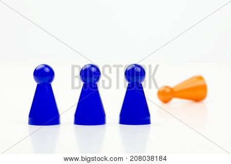 Close-up photo of a group of different-colored pieces in different positions on a white background - applicable to the team view