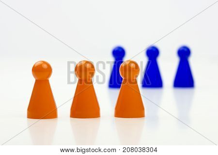 Close-up photo of a group of different-colored pieces in different positions on a white background - applicable to the team view