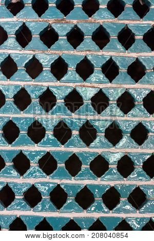 Patterned wall in blue ceramics with holes