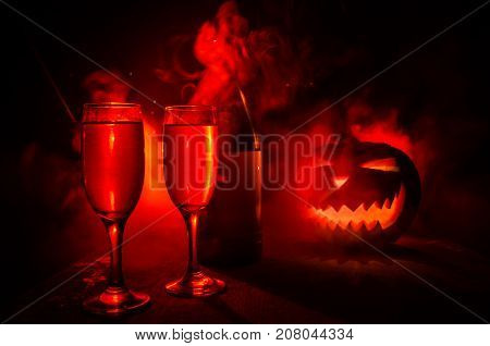 Two Glasses Of Wine And Bottle With Halloween - Old Jack-o-lantern On Dark Toned Foggy Background. S