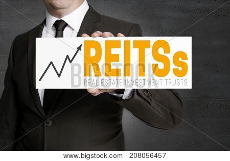 Reits Sign Is Held By Businessman