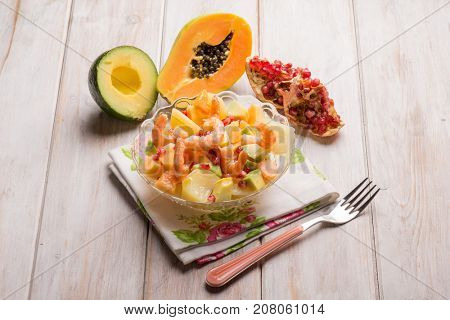 shrimp salad with potatoes avocados papaya and pomegranate
