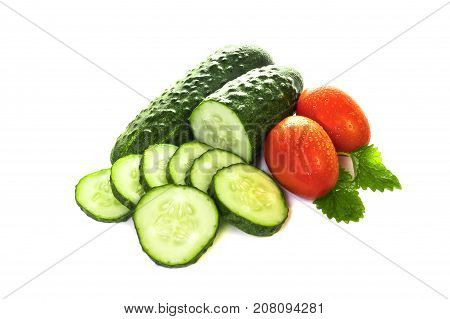 vegetables cucumbers and tomatoes on a white background