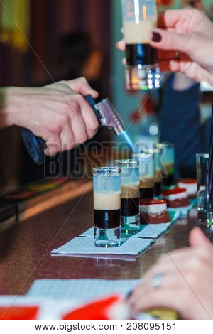 Preparation of shots cocktails. B-52 close-up