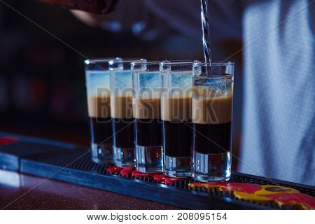 Preparation of shots cocktails. B-52 close-up