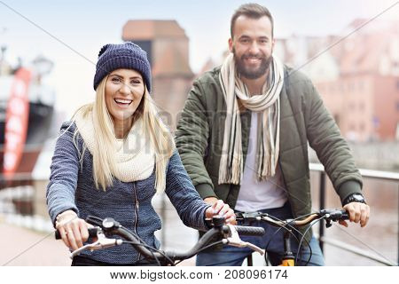 Young couple riding bikes and having fun in the city