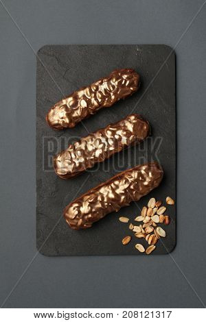 chocolate golden eclairs with caramel, peanuts, and chocolate icing