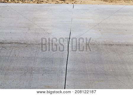 Details Of The New Road Poured Out Of Gray Concrete. Photo Close-up, Side View Of The Connection Lin