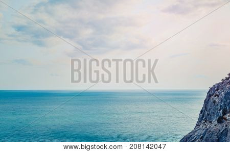 Aerial view on the beach of Sudak in Crimea, Black Sea coast. Fun on the water. Landscape view to the mountains and sea. Horizon line from the top of the mountain.