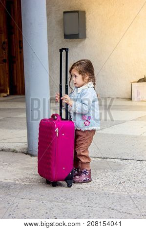 Little girl travel alone. Now she on the railway station
