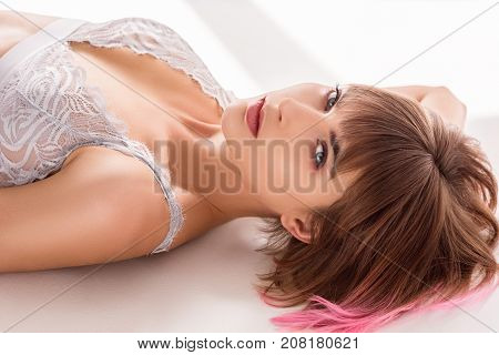 Woman In Lace Bralette Lying On Floor