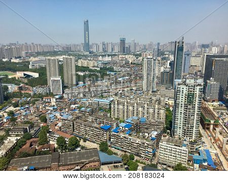 Wuhan Hubei China, 14 September 2017: Aerial view of Hankou district in Wuhan city with residential area and Wuhan Center super tall skyscraper in background