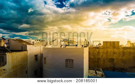 Hammamet, Tunisia. Image of architecture of old medina with dramatic sky at sunset time.