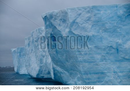 A large tabular iceberg floating in the southern atlantic ocean, near Antarctica.