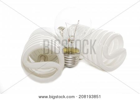 Several different led bulbs and compact fluorescent lamps with the size of the male screw base E27 on a light background