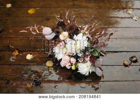 top flower bouquet on wooden floor after raining day
