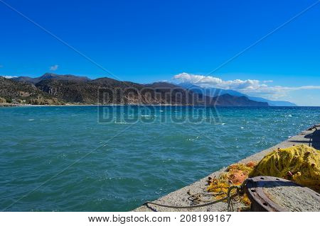 View of the ocean from the Paleochora pontoon with a fishing net in the foreground on the island of Crete