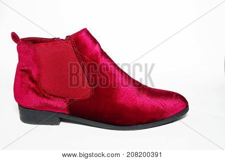 Lady's red velvet ankle boots isolated on white background.