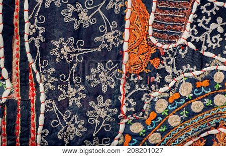 Pieces of retro cloth in patchwork style. Patterns on texture of vintage blanket surface with flowers.