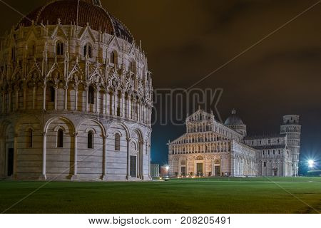 PISA, ITALY - SEPTEMBER 19, 2014: The world famous Piazza dei Miracoli by night in Pisa, Tuscany.  The construction of the cathedral was begun in 1064.