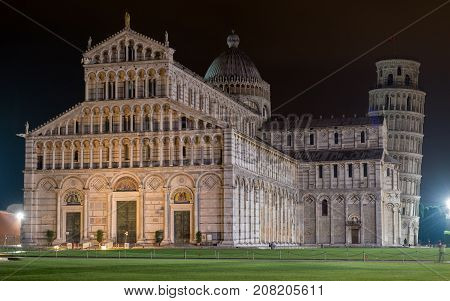 PISA, ITALY - SEPTEMBER 19, 2014: The world famous Piazza dei Miracoli by night in Pisa, Tuscany.  The construction of the cathedral was begun in 1064.