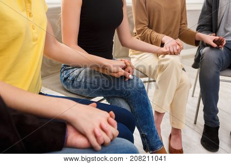 Trust circle. Company of people sitting together with united hands. Meeting of support group