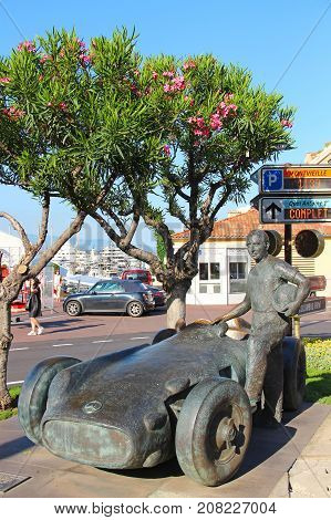 MONACO - JUNE 24, 2016: Juan Manuel Fangio memorial at the Grand Prix circuit in Monaco. The statue depicts the 5-time Formula One World Champion standing next to his Mercedes-Benz Grand Prix racer