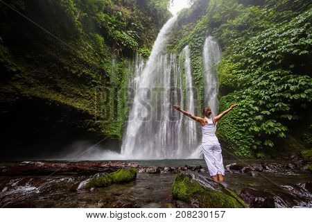 Woman Meditating Doing Yoga Between Waterfalls
