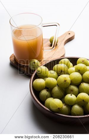 Indian fresh gooseberry juice or stock photo of Amla juice (Phyllanthus emblica) , selective focus