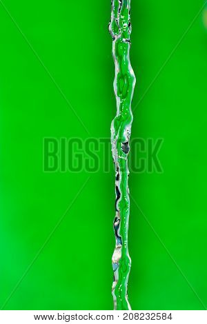 a jet of water on a green background