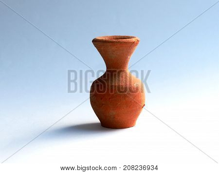 Small clay vase on a white-blue background