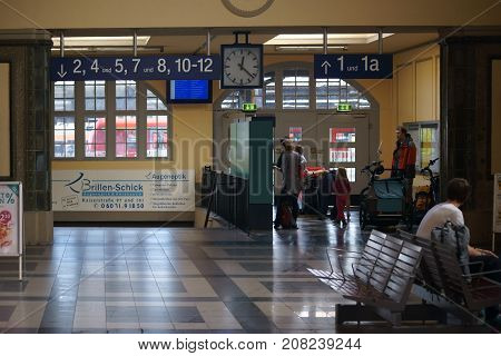 FRIEDBERG, GERMANY - OCTOBER 03: Travelers stand and sit in the station hall of the Friedberg train station on October 03 2017 in Friedberg.
