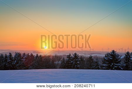 Snowy winter Christmas Landscape.Winter sunset over the snow-covered trees.