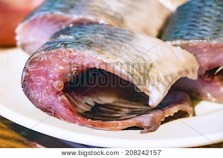Pieces of fish, Pieces of herring on the plate. Selective focus