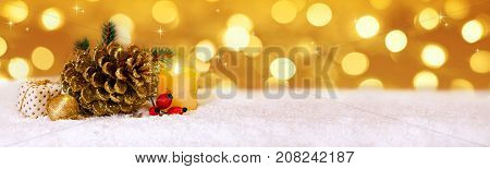 Avent candle and golden fir cones decoration. Christmas decoration and white snow.