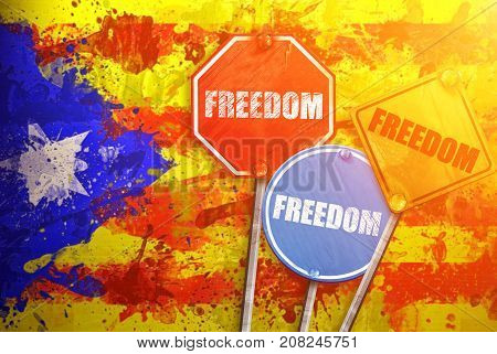 Political slogan in the form of traffic signs with Flag of Catalonia on the background. Signs with word FREEDOM. Independence of catalonia. Referernundum and protests in Catalonia, Barcelona.