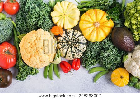 Above view of assorted colored rainbow vegetables on the light grey background, copy space for text below, selective focus