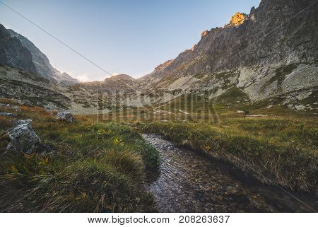 Creek in the Valley under the Mountain Peaks at Sunset. Velicka Valley High Tatra Slovakia.