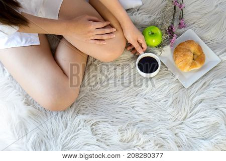 Young Woman In White Shirt Getup From Her Bed
