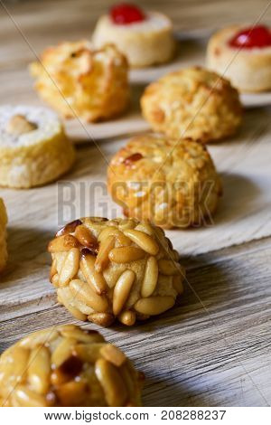 closeup of some panellets, typical confection eaten in All Saints Day in Catalonia, Spain, on a wooden table