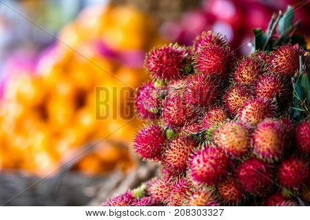 Assortment of fresh exotic rambutan fruits on market stall