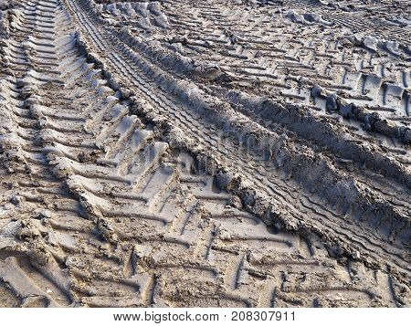 Track of tractor tires wheels on mud ground soil agriculture background image