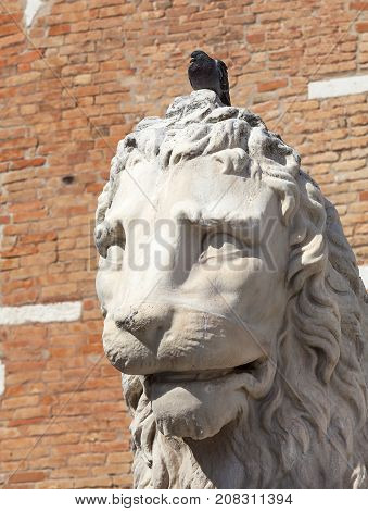 Venetian Arsenal old shipyard stone lion Venice Italy. Construction of the Arsenal began in the 12th century it was the largest industrial complex in Europe before the Industrial Revolution