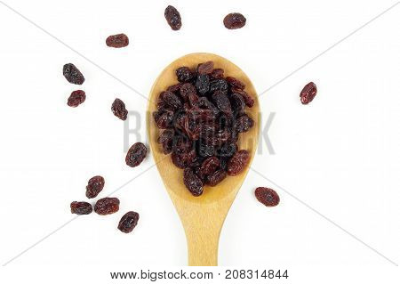 black raisins isolated on white and wooden background