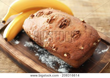 Tasty banana nut bread on wooden board